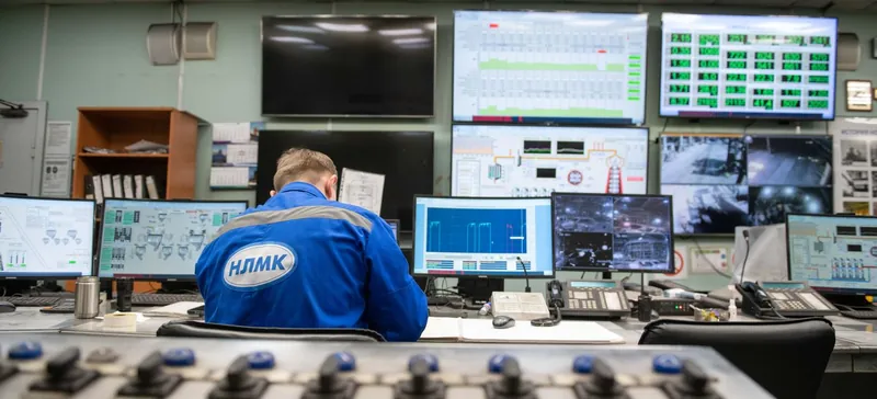 Stock photo: an operator at a control room desk facing monitoring screens