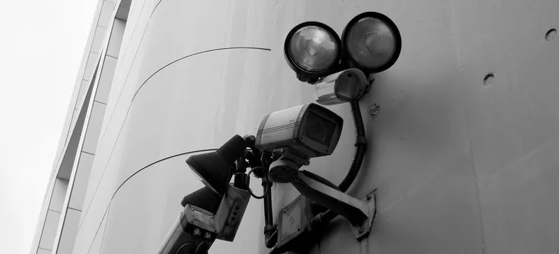 Stock photo: a surveillance camera with spotlights on a wall